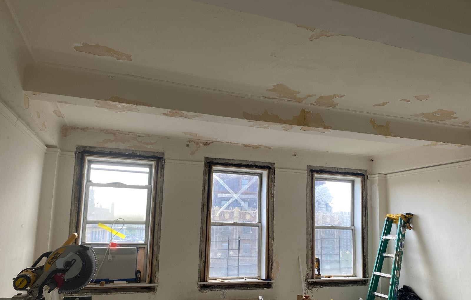 Apartment windows and surrounding painted surfaces prepared for controlled abatement work