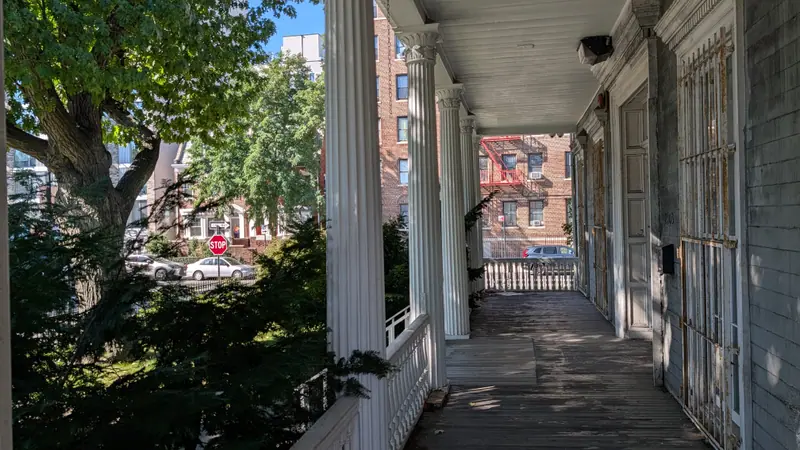 Porch of a pre-war wood-frame building where painted surfaces are tested for lead