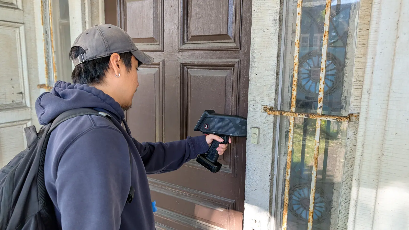 Manhattan Lead inspector testing a painted front door for lead with a handheld SciAps X550PB XRF analyzer
