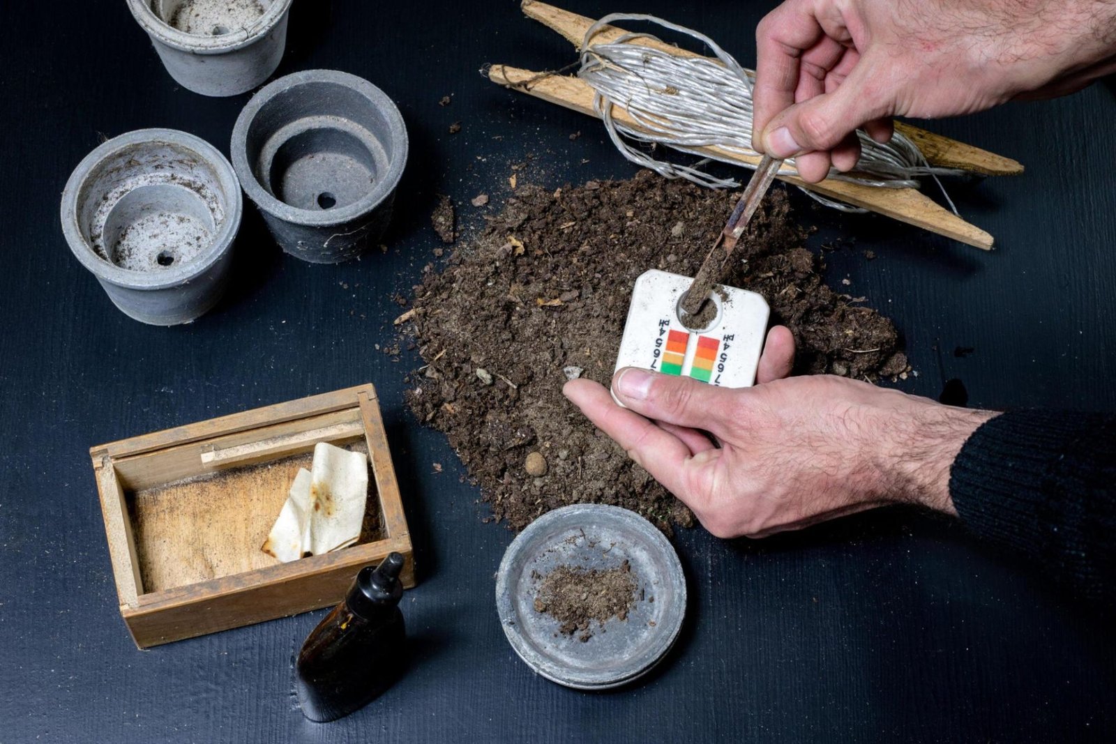 Hands preparing a soil sample for lead testing